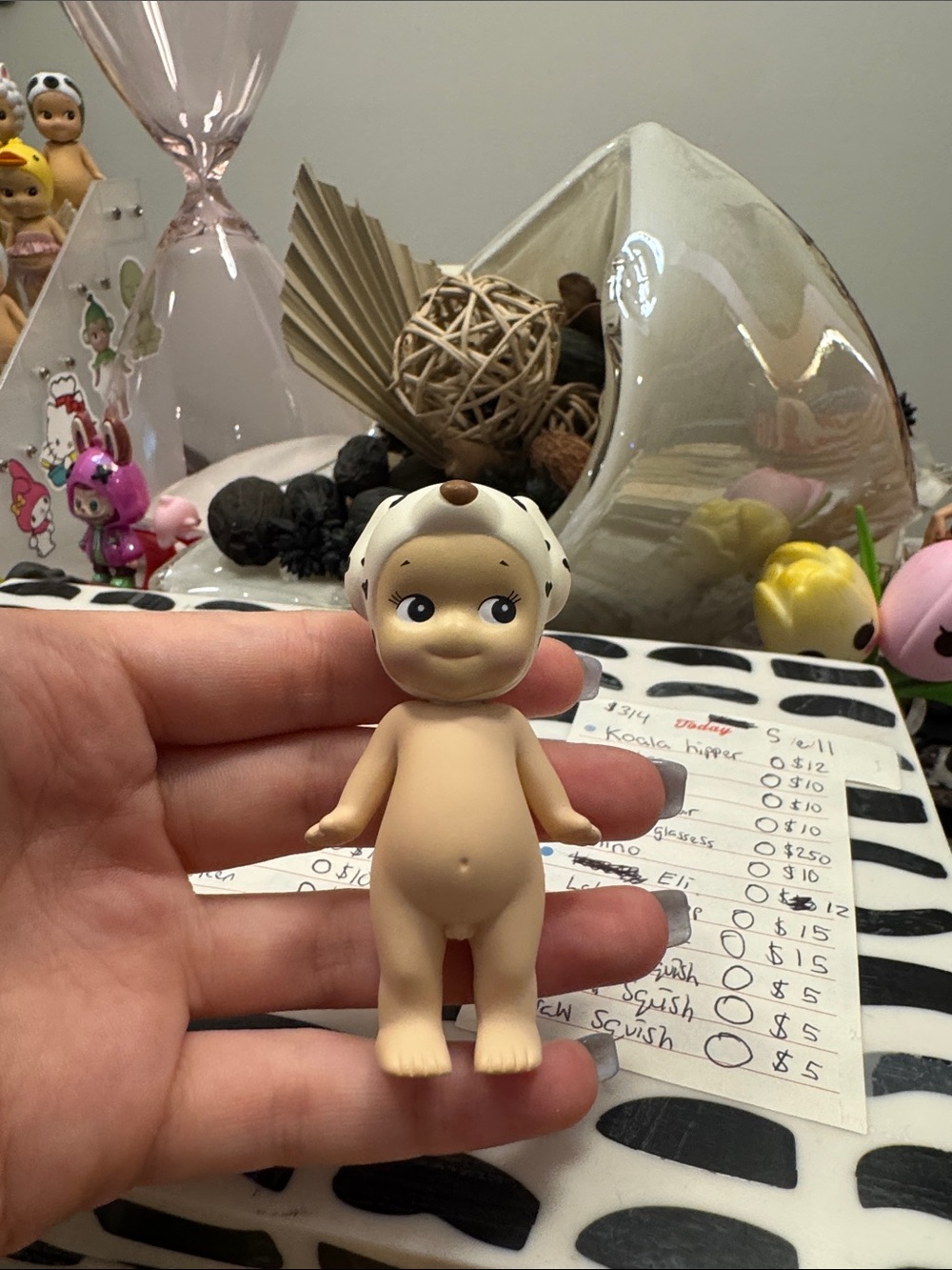 Beige Baby Doll Figurine with White Dalmatian Cap - Collectible Toy